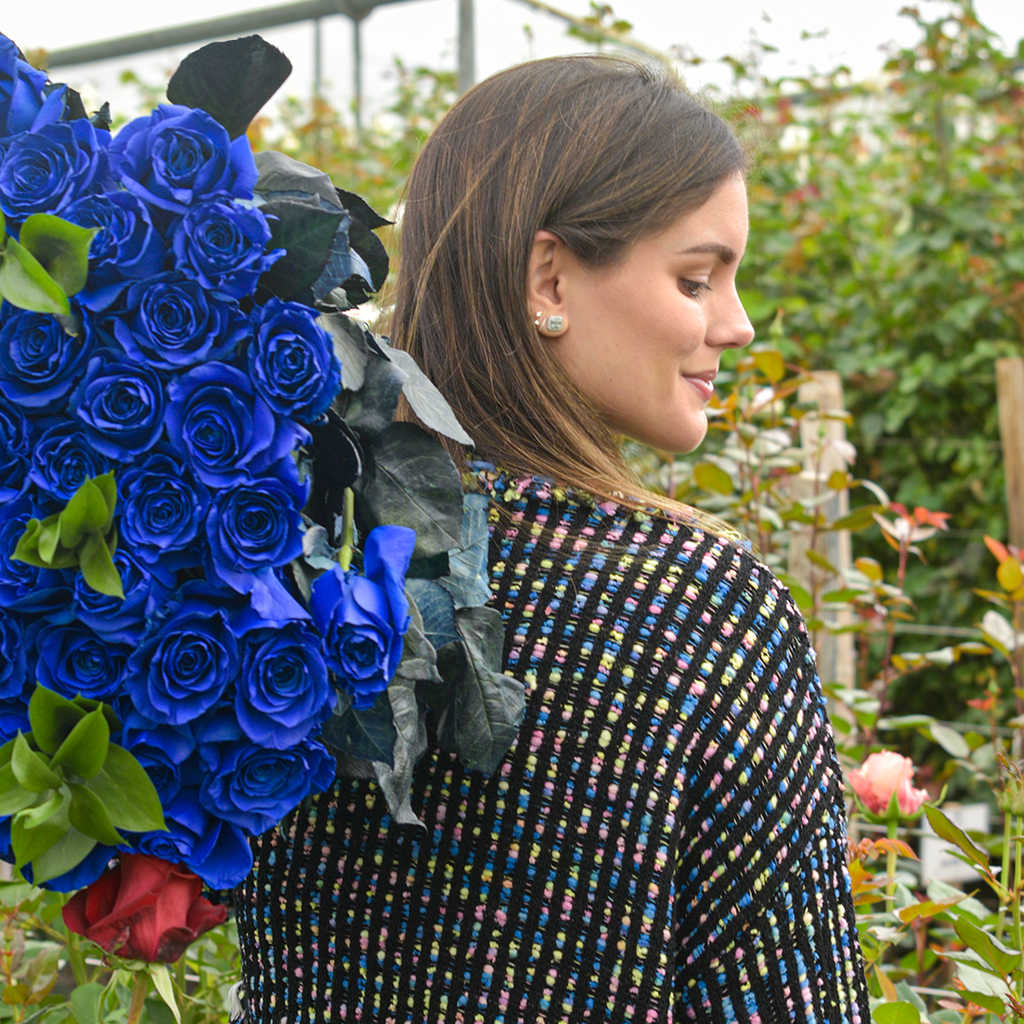 A girl is holding the Blue Lagoon rose bouquet