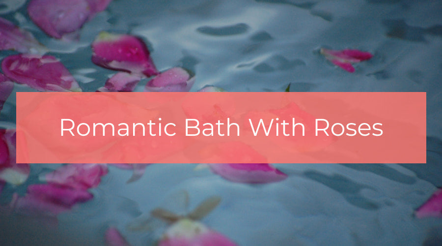 Bathtub filled with foam and rose petals prepared for romantic