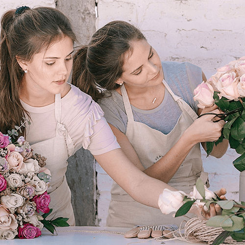 Two florists make bouquets of roses