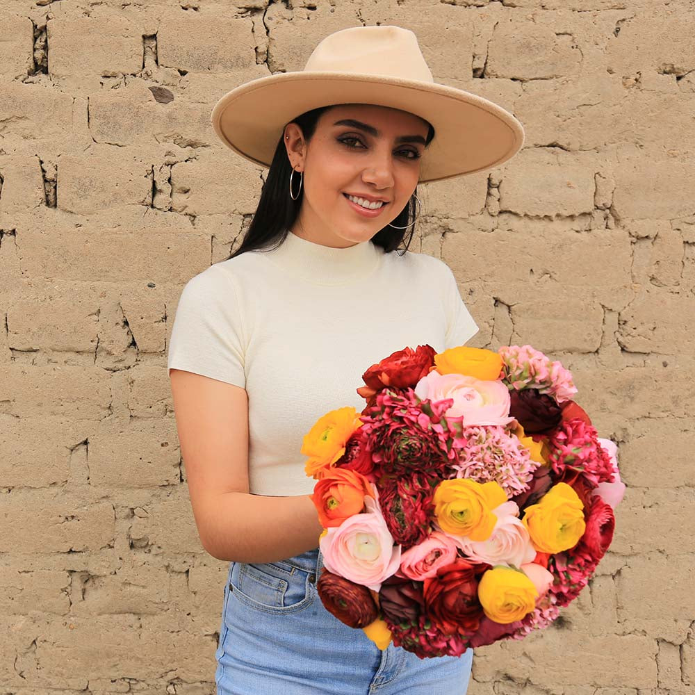 A girl is holding a Campanita bouquet - Ranunculus Flower Bouquet by Rosaholics