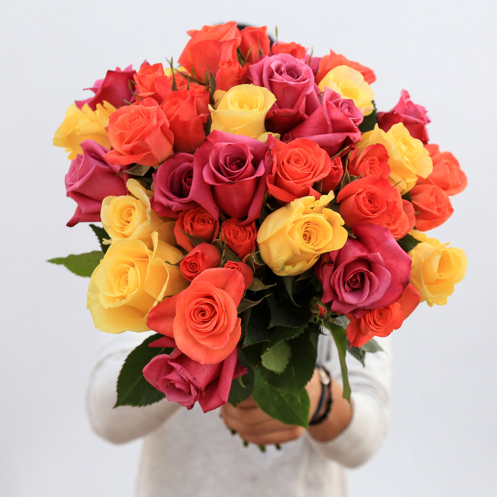 bouquet of bright roses in the men's hands