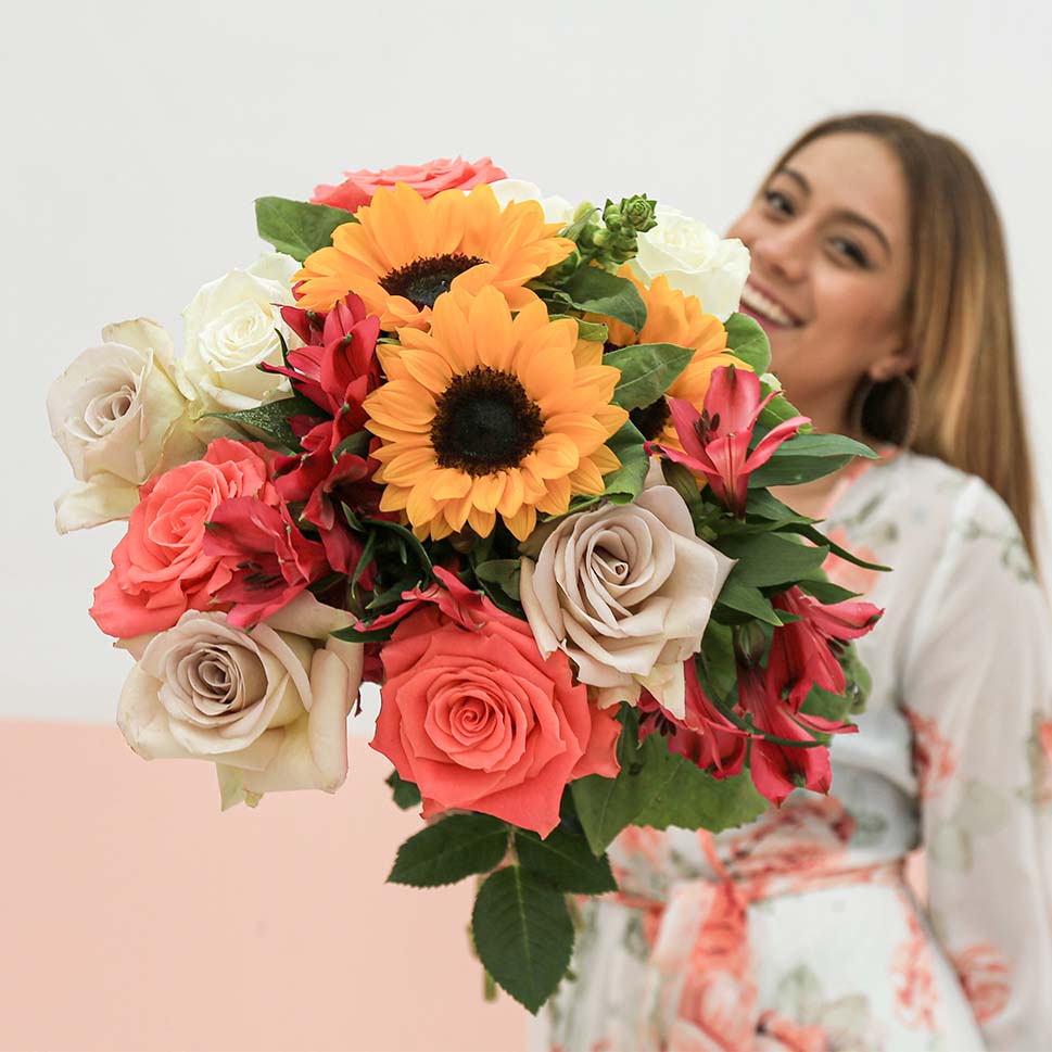 A young woman is holding a  LOVE YOU FOREVER Bouquet - Roses and Sunflowers