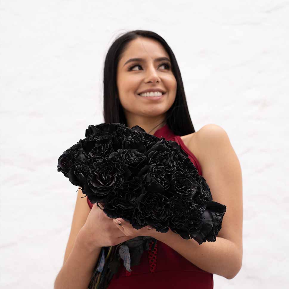 A young woman is holding a Black Dragon bouquet - black roses