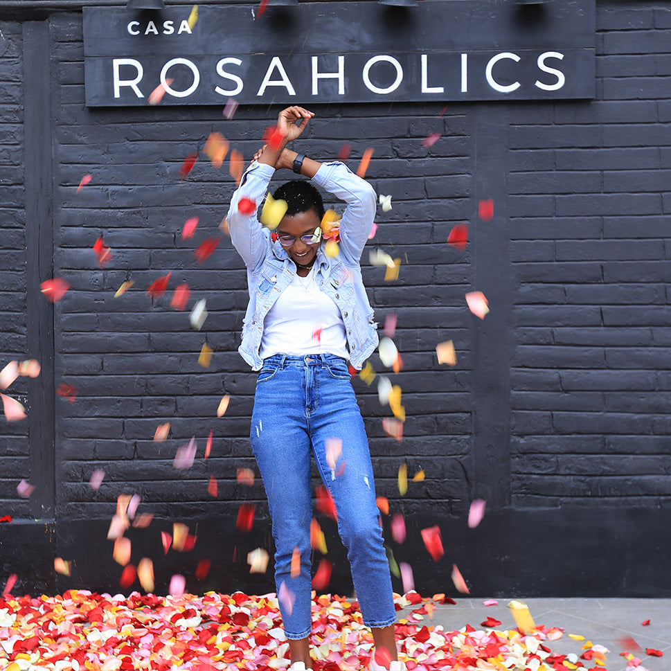 young woman in fresh rose petals