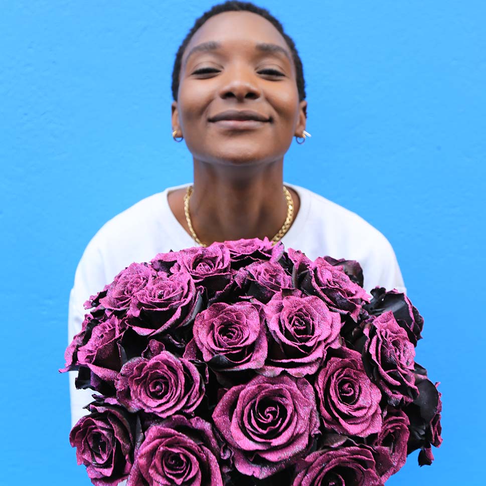 A young woman is holding a Savage bouquet