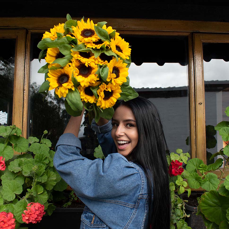 A young woman is holding a Sunflower bouquet 